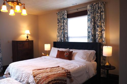 a bedroom with a large bed and a window at Firefly Hills in Beattyville
