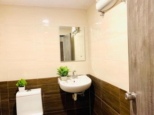 a bathroom with a sink and a mirror at Hotel MN Grand Shamshabad Airport Zone Hyderabad in Shamshabad