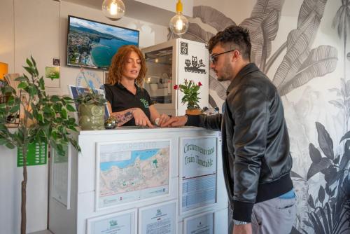 a man and a woman standing behind a counter at B&B Sorrento Central in Sorrento