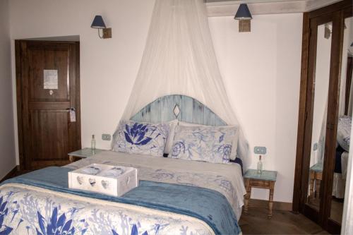 a bedroom with a large bed with a box on it at Caledonia B&B in Mercato San Severino