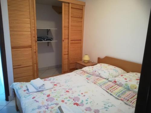 a bedroom with a bed and a wooden closet at Green House Villa with Pool in Banjole