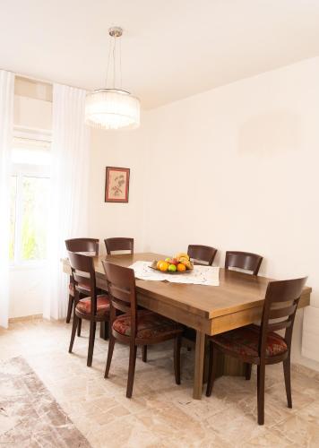a dining room with a wooden table and chairs at Exclusive Jerusalem Villa in Jerusalem