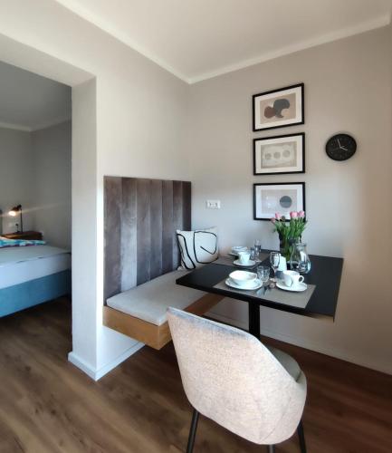 a dining room with a table and chairs and a bed at Haus Nowak Ferienwohnungen in Millstatt