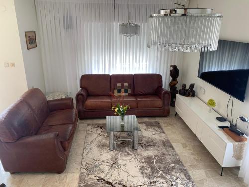a living room with a couch and a table at Exclusive Jerusalem Villa in Jerusalem