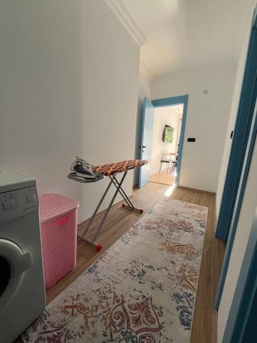 a laundry room with a washing machine and a rug at Sea Life Homes in Kemer