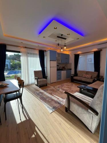 a large living room with a couch and a table at Sea Life Homes in Kemer