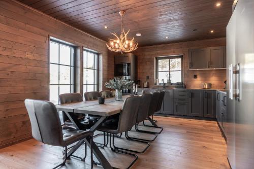 a kitchen and dining room with a table and chairs at Idre Sky Mountain Lodge- Ski in Ski out in Idre