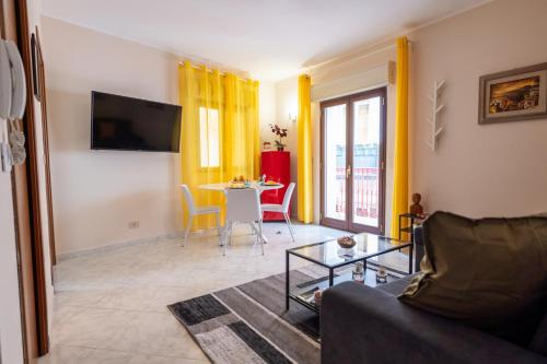a living room with a couch and a table at Appartamento Georgiana in Taormina
