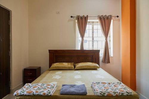 a bed with two pillows on it in a bedroom at Cozy 3 bhk A/C home @ wipro circle , Near US Embassy in Hyderabad