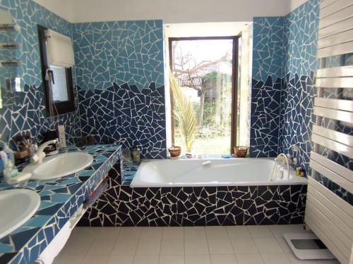 La salle de bains est pourvue de 2 lavabos, d'une baignoire et d'une fenêtre. dans l'établissement PRESTIGE PROPERTY WITH PANORAMIC SEA VIEW, à Vallauris