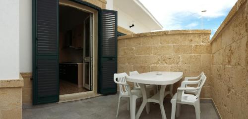 a white table and white chairs on a patio at Casa Roberto in Campomarino