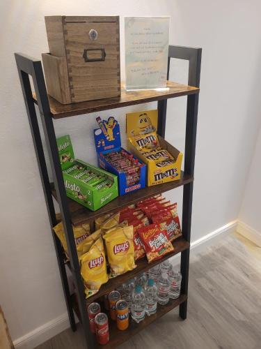 a shelf with food and drinks on it at Airbnb, moderne, ruhige und helle Doppelzimmer, nähe Magdeburg, A14 & A2 in Dahlenwarsleben
