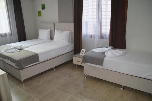 Postel nebo postele na pokoji v ubytování Hotel Hugo
