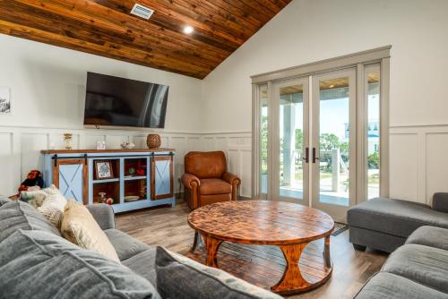 uma sala de estar com um sofá e uma mesa em The Periwinkle - 344 Audubon home em Dauphin Island