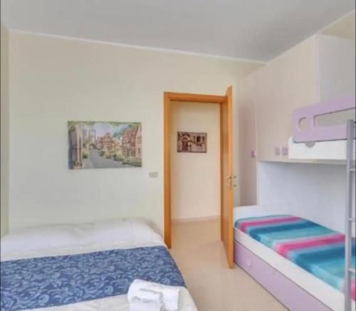Postel nebo postele na pokoji v ubytování L’orchidea rooms, cucina e bagno in comune