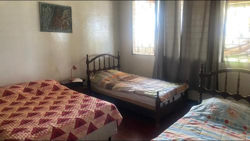 1 dormitorio con 2 camas y 2 ventanas en Casa pulpo en León