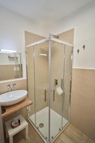 a bathroom with a glass shower and a sink at Toto e Peppino Luxury Rooms in Naples