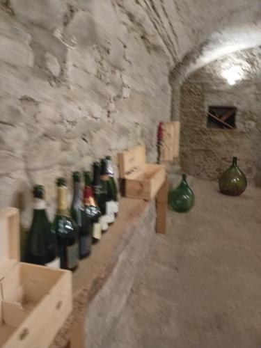a bunch of bottles of wine sitting on a wall at B&BLe Tre Gemme in Montechiarugolo