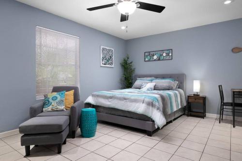 a bedroom with a bed and a chair and a ceiling fan at Oak Ridge 5 in McAllen