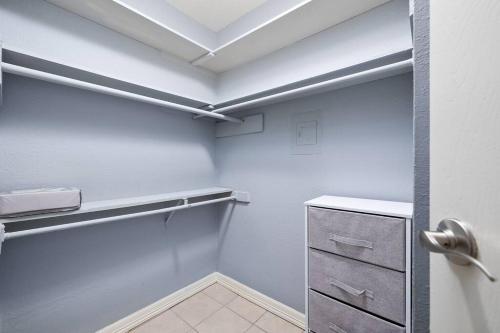 a walk in closet with white walls and a drawer at Oak Ridge 5 in McAllen