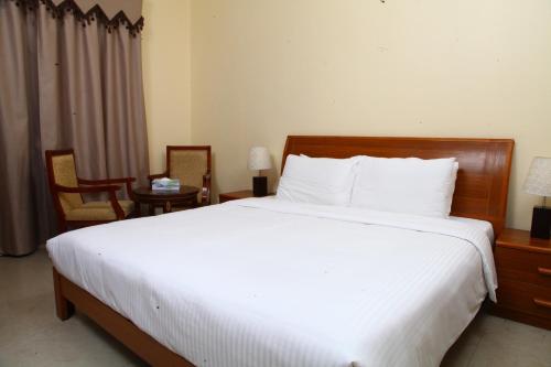 a bedroom with a large bed with white sheets at Dream Palace Hotel in Ajman 