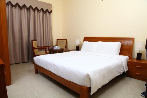 a bedroom with a large bed with white sheets at Dream Palace Hotel in Ajman 