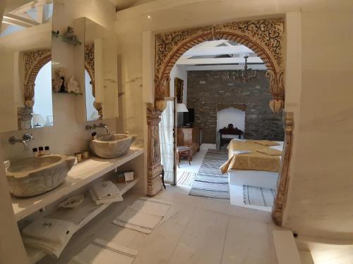 a bathroom with two sinks and a fireplace at Villa Domatia in Kavala