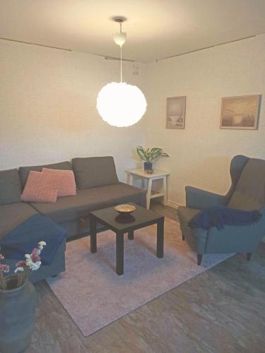 a living room with a couch and a table at Ängelholm boende in Ängelholm