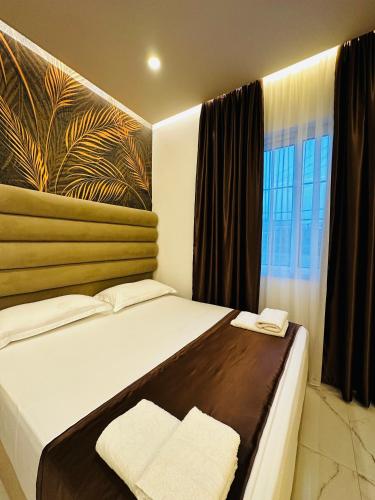 a bedroom with a bed with two towels on it at Apartments Oda Hotel in Velipojë