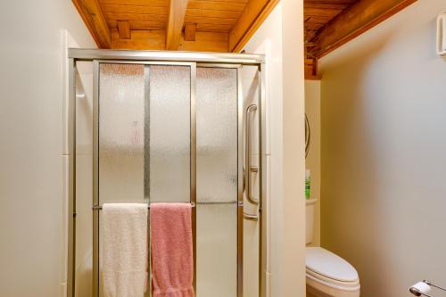 a bathroom with a shower with three towels at Peaceful Luray Cabin with Hot Tub, Deck and Fire Pit! in Luray