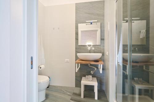 a bathroom with a sink and a toilet at Toto e Peppino Luxury Rooms in Naples