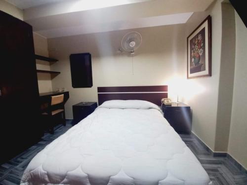 a bedroom with a large white bed in a room at Hotel Perú Pacífico in Lima