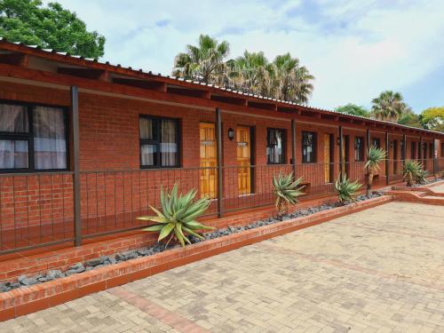 a brick building with plants in front of it at Snips Accommodation in Newcastle