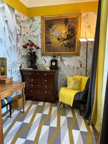 a living room with a dresser and a painting on the wall at La maison au cèdre in Marsac-sur-lʼIsle