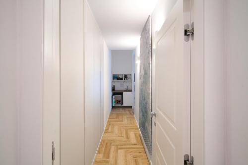 a hallway with white doors and wooden floors at Toto e Peppino Luxury Rooms in Naples