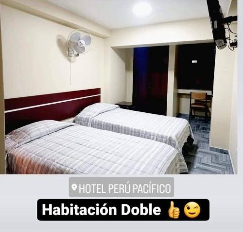 a hotel room with two beds and ahibmissionodavertisementvertisementvertisementvertisementvertisement at Hotel Perú Pacífico in Lima