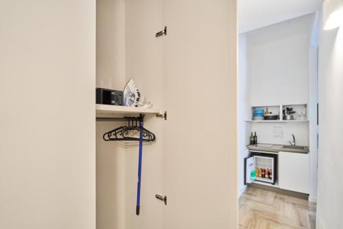 a hallway with a white door with a blue cord on it at Toto e Peppino Luxury Rooms in Naples
