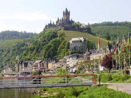 a bridge over a river with a castle on a hill at Ferienhaus Wagner in Weiler