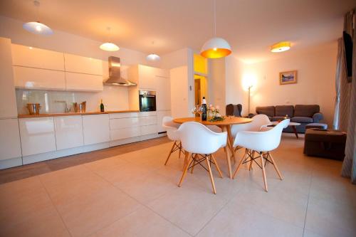 a kitchen and living room with a table and chairs at Polo Villa & Suites in Podstrana