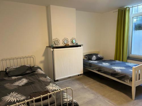 1 dormitorio con 2 camas y radiador en Chambre 2 lits simples en Bruselas