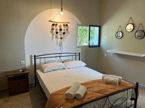 a bedroom with a bed with two towels on it at Village Holidays - Chelonaria in Chrani