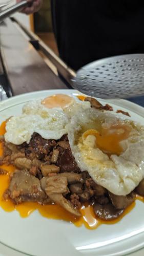 a plate of food with a fried egg on top at Hotel de Montaña La Hortizuela in Coto Rios