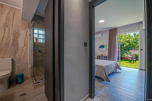a room with a bathroom with a bed and a shower at “Villa Chrysa” luxury house in Flámbouras