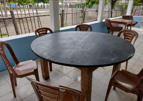 a black table and chairs on a patio at Luz del Mar Bungalos in Sipacate