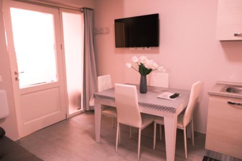 a dining room with a table with a vase of flowers at La Ponzianina in Spoleto