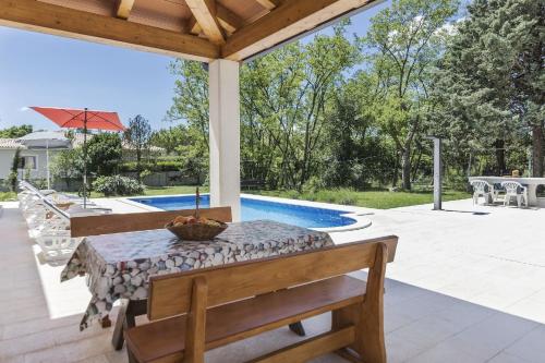 a patio with a table and a pool at Ferienhaus mit Privatpool für 12 Personen ca 254 qm in Labin, Istrien Bucht von Raša in Labin