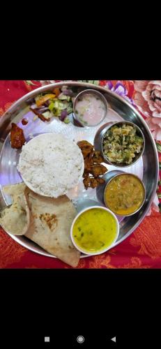 a plate of food with different types of food on it at Anandi Nivas in Talavda