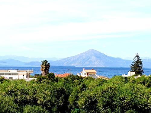 a view of a mountain and the ocean with houses at “Villa Chrysa” luxury house in Flámbouras