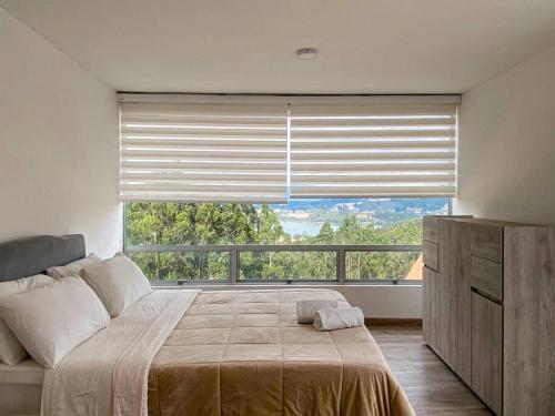 Ένα ή περισσότερα κρεβάτια σε δωμάτιο στο La Esperanza Lakeview - Paipa