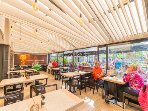 a restaurant with tables and people sitting at tables at Lace Hotel in Bruges